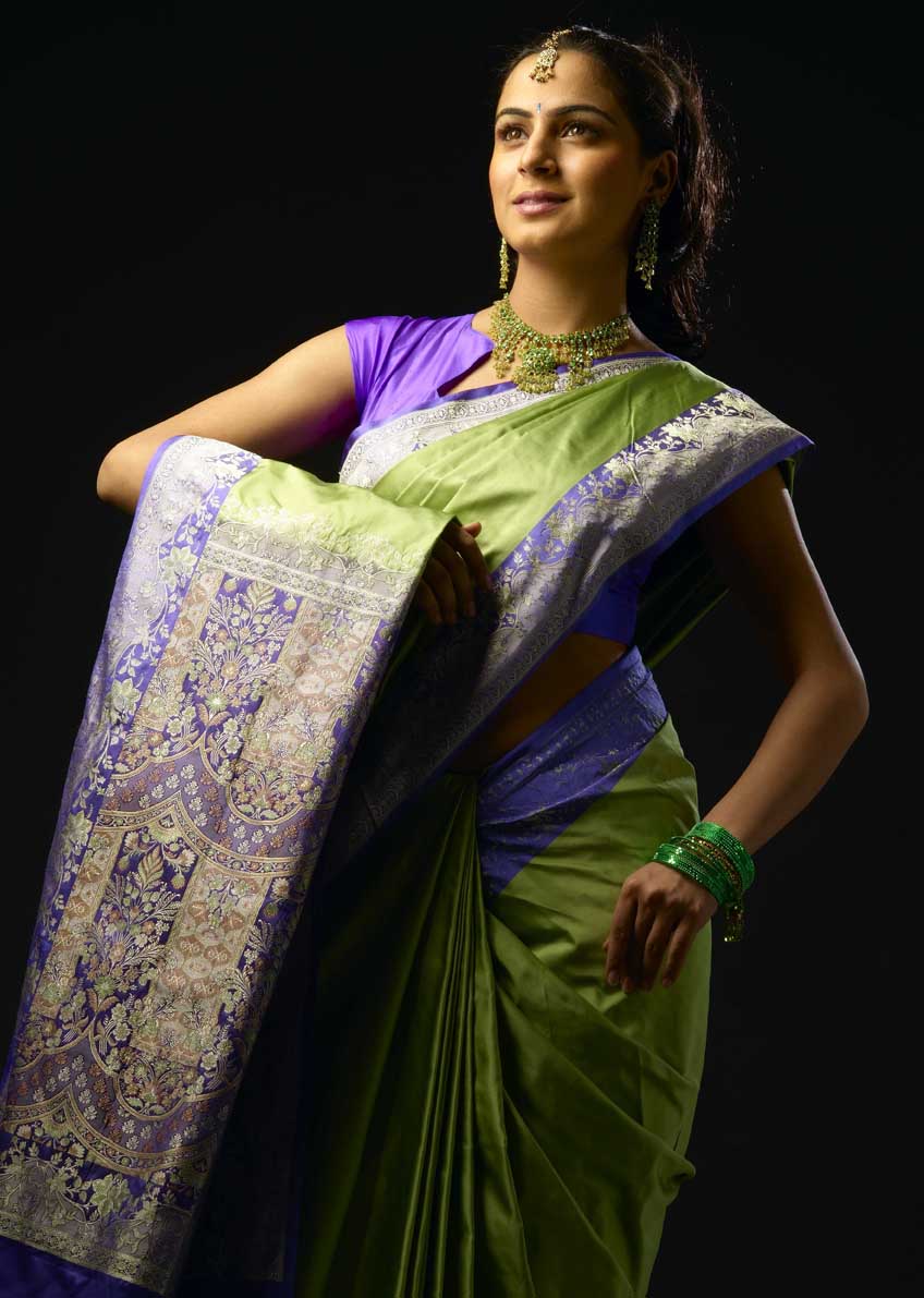 Woman modelling a green and violet brocade sari